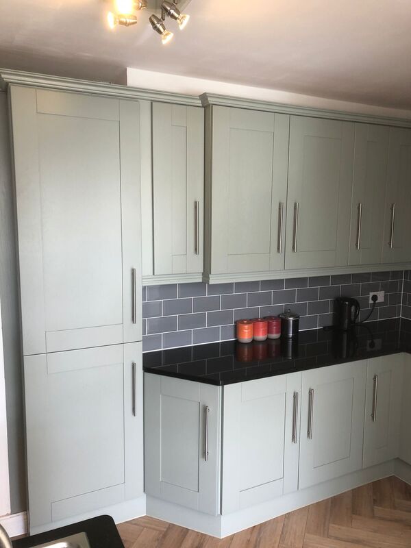 Kitchen after spray painting of cupboards in light grey